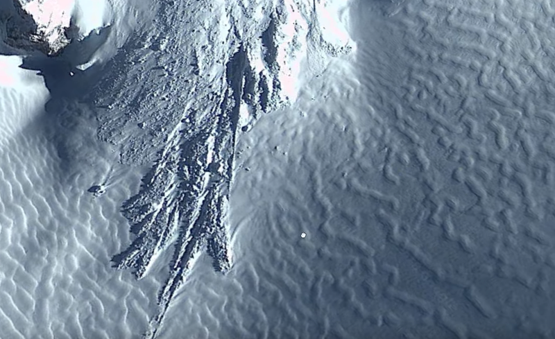 The debris field, or landslide deposit, trailing from the nearby mountain.
